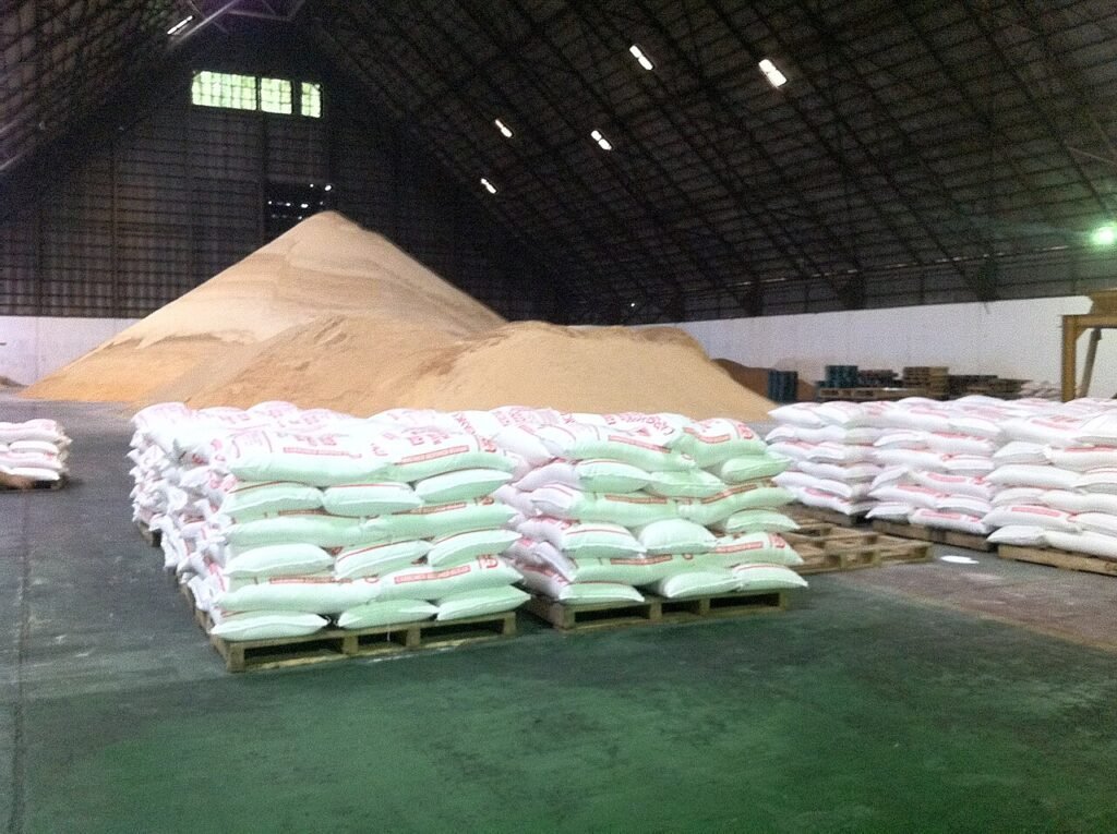 sugar sacks stacked in storage before delivery to a bakery