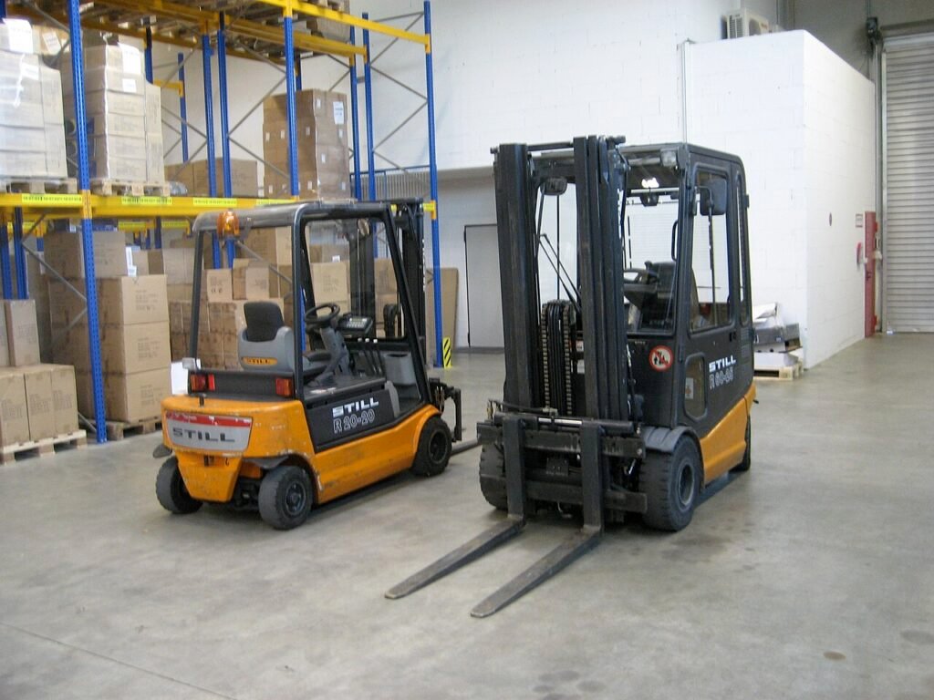 forklift moving pallets of bagged sugar
